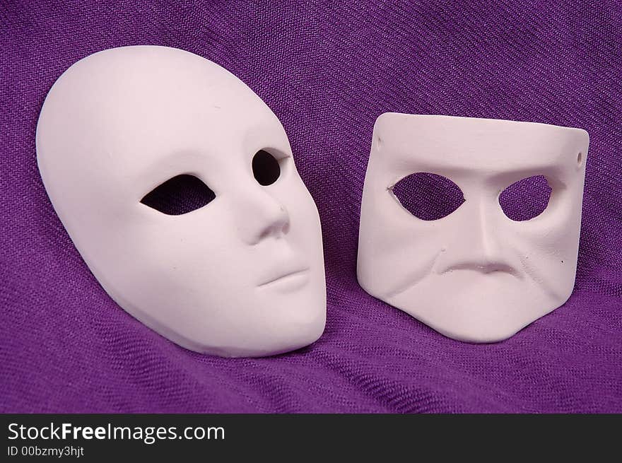 Couple of Venice carnival mask on purple sheet