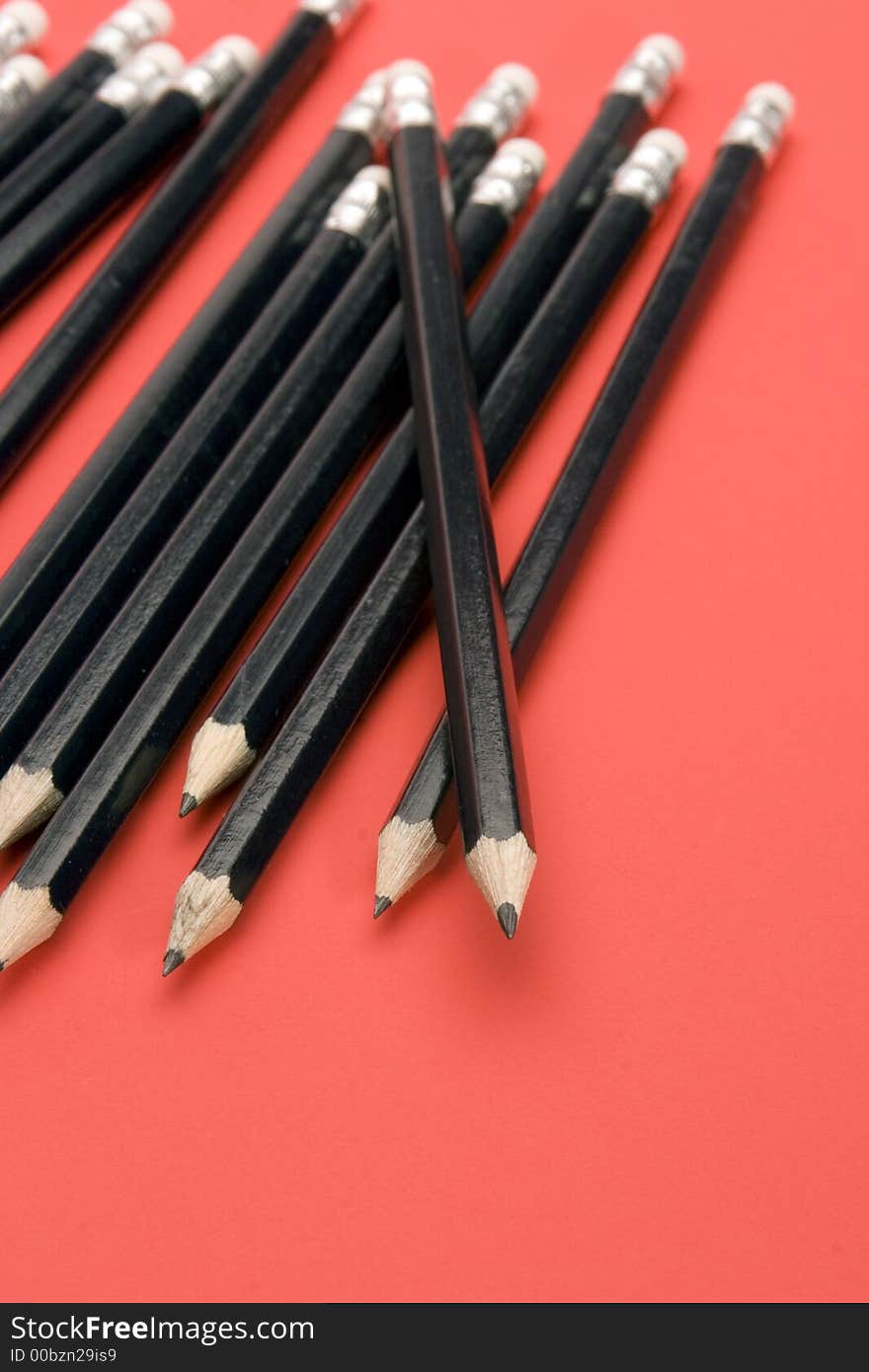 Black Pencils set against a Red Background.