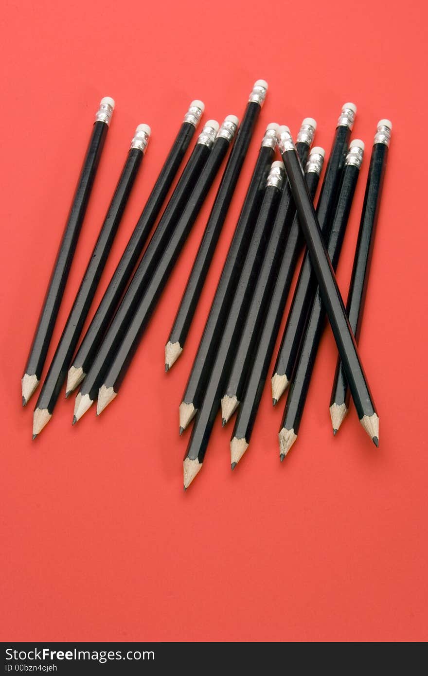 Black Pencils set against a Red Background.