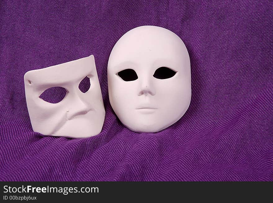 Couple of Venice carnival mask on purple sheet