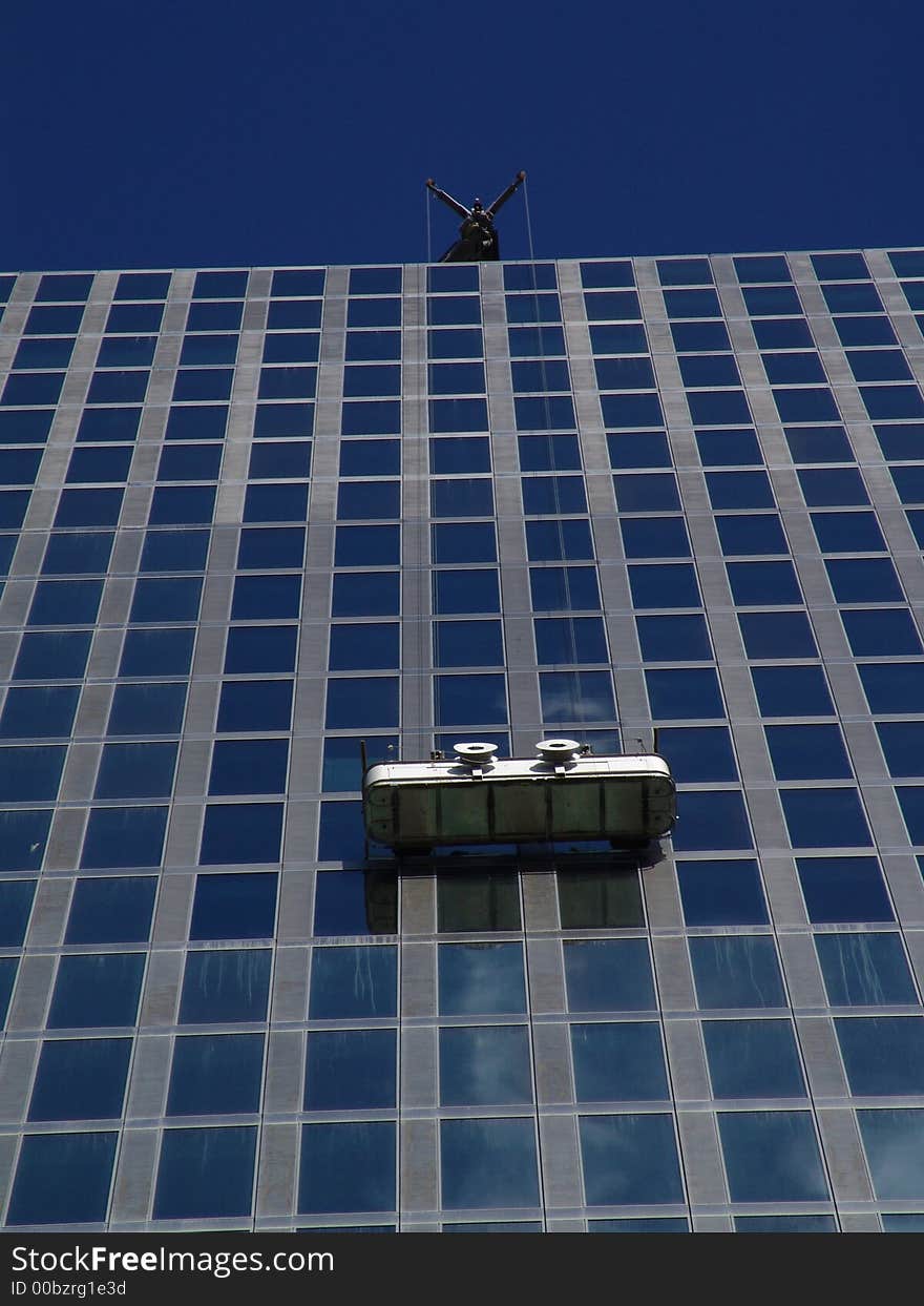 Window cleaners at their job. Window cleaners at their job.