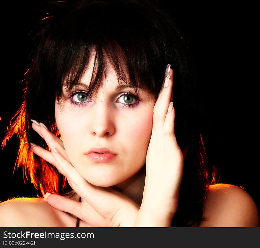 Beautiful young woman over black background. Beautiful young woman over black background.