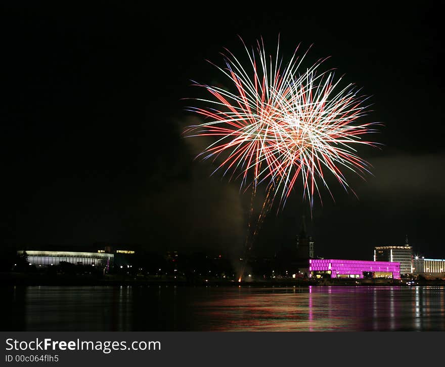 Fireworks in Linz (Austria) at the Danube river with beautiful reflections. On the right side the Brucknerhaus (orchestra house) on the left the Lentos (Museum) with its illuminated walls. Fireworks in Linz (Austria) at the Danube river with beautiful reflections. On the right side the Brucknerhaus (orchestra house) on the left the Lentos (Museum) with its illuminated walls.