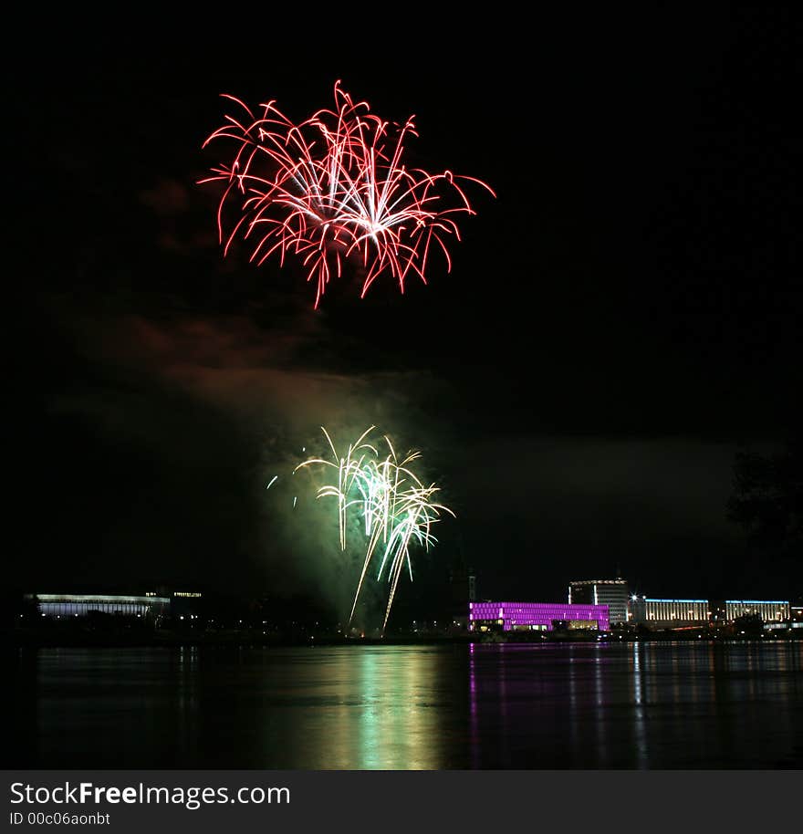 Fireworks in Linz (Austria) at the Danube river with beautiful reflections. On the right side the Brucknerhaus (orchestra house) on the left the Lentos (Museum) with its illuminated walls. Fireworks in Linz (Austria) at the Danube river with beautiful reflections. On the right side the Brucknerhaus (orchestra house) on the left the Lentos (Museum) with its illuminated walls.