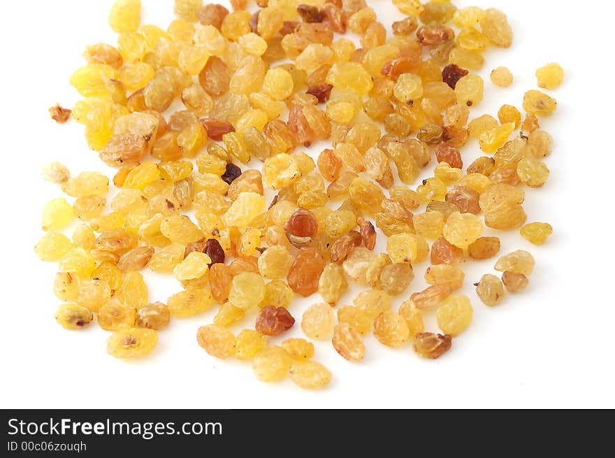 Yellow raisins on the white background