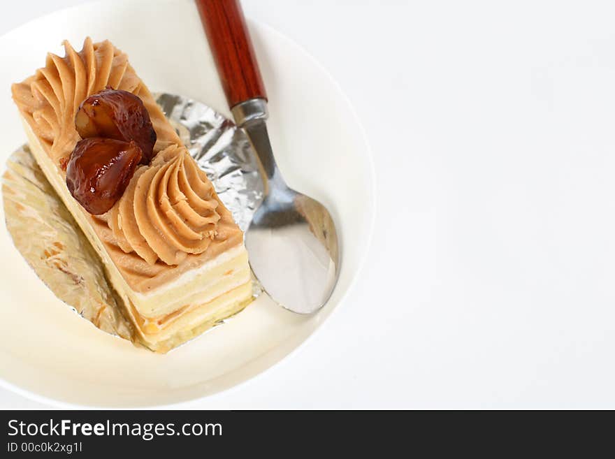 Upper view of a tasty chestnut cake on a plate with spoon. Upper view of a tasty chestnut cake on a plate with spoon.