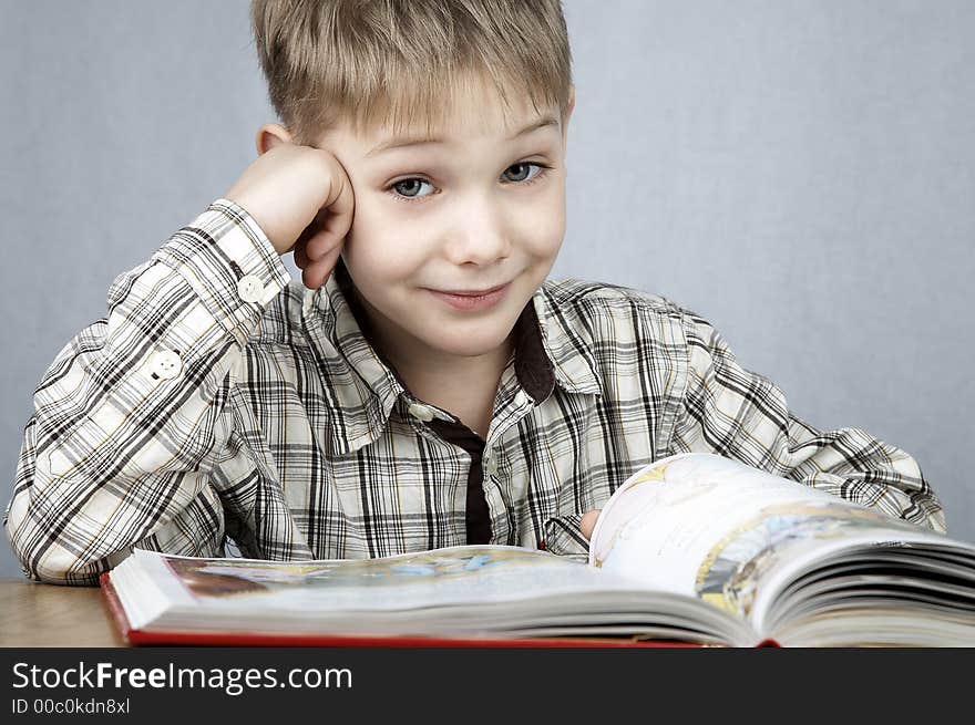 Little smiling boy with big book. Little smiling boy with big book