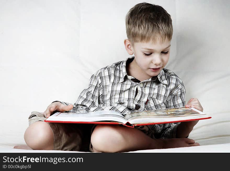 Little serious boy with big book. Little serious boy with big book