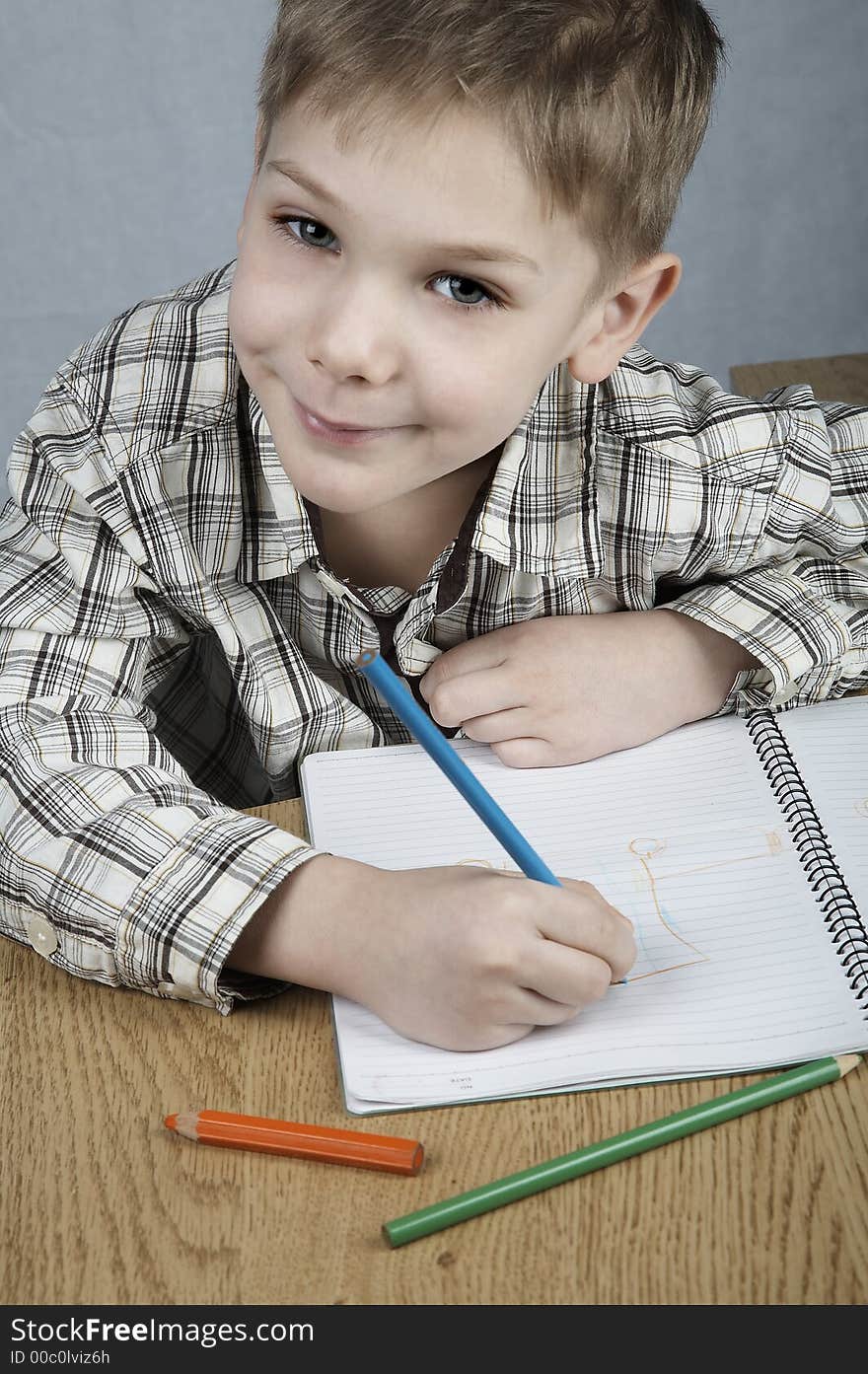 Smiling drawing boy with notepad and pencils. Smiling drawing boy with notepad and pencils