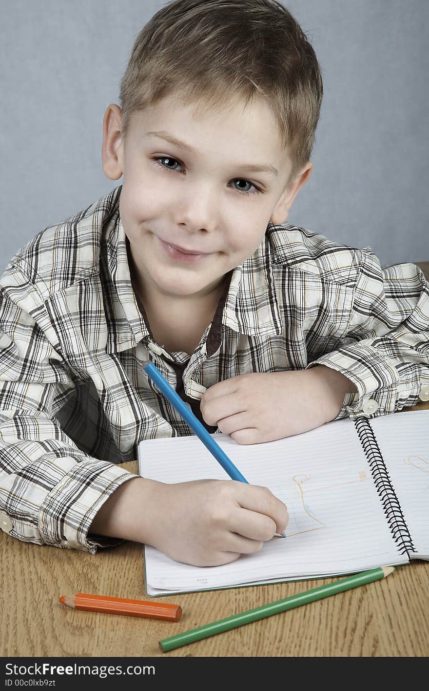 Smiling drawing boy with notepad and pencils. Smiling drawing boy with notepad and pencils