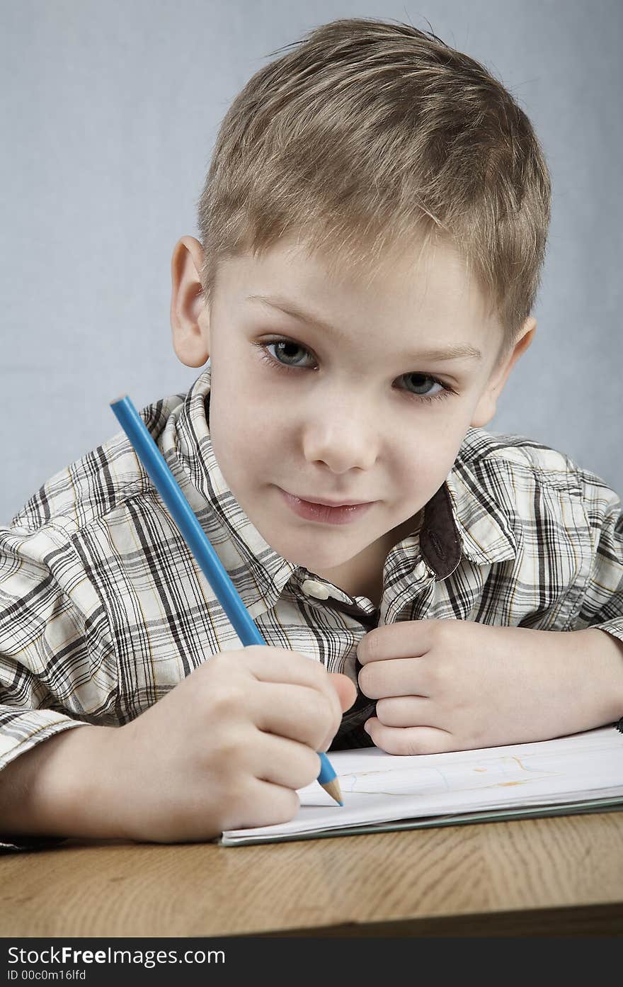 Smiling drawing boy with notepad and pencil. Smiling drawing boy with notepad and pencil