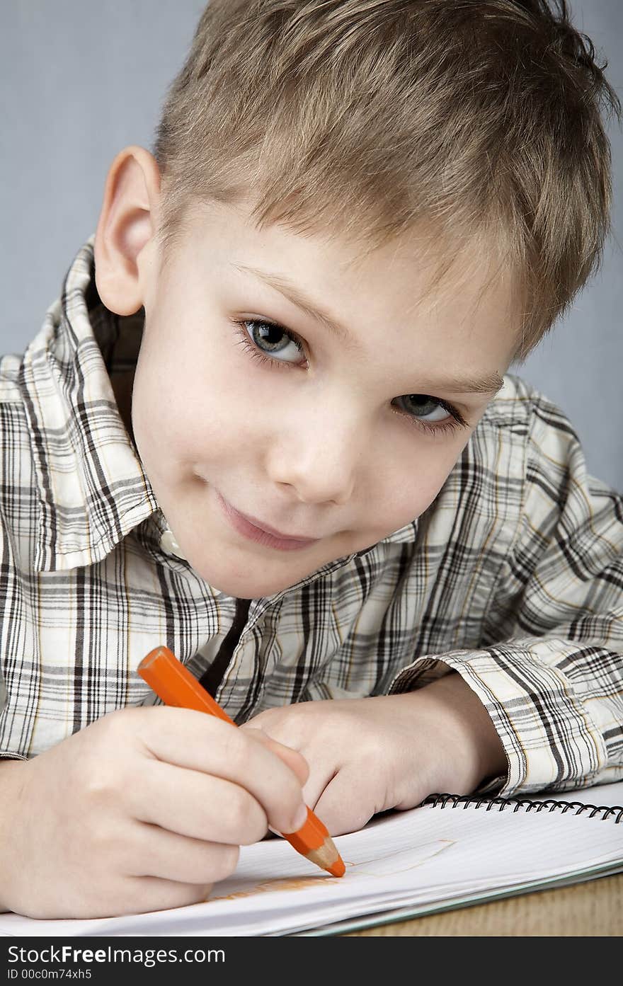 Smiling drawing boy with notepad and pencil. Smiling drawing boy with notepad and pencil