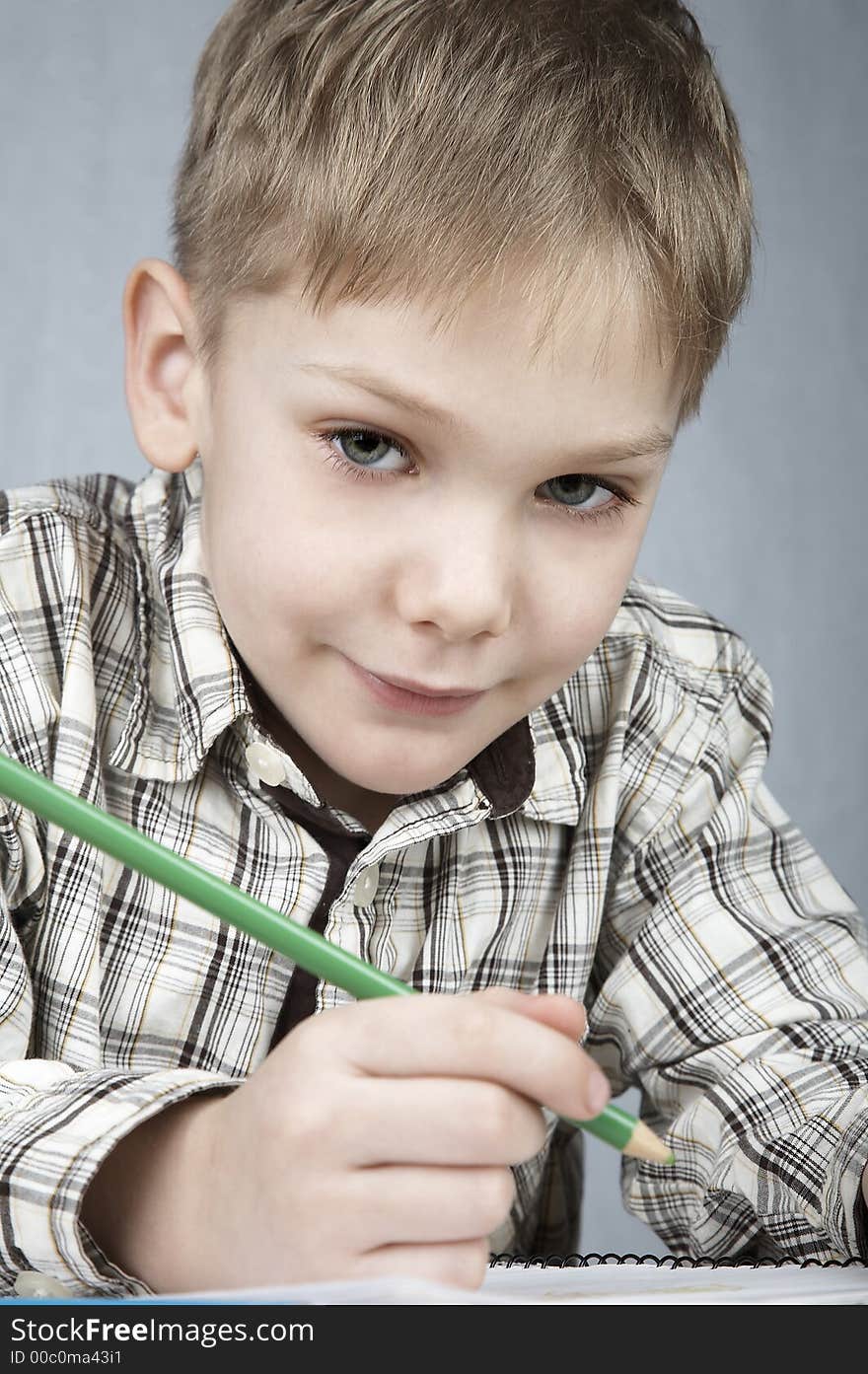 Smiling drawing boy with notepad and pencil. Smiling drawing boy with notepad and pencil