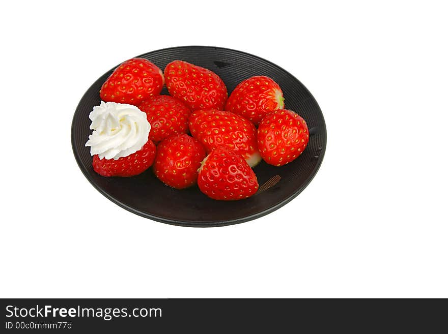 Strawberries with whipped cream on a black plate-isolated over white background. Strawberries with whipped cream on a black plate-isolated over white background