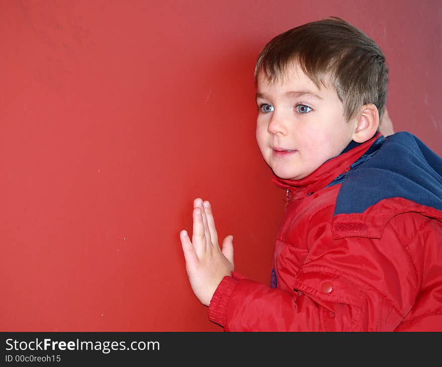 Boy portrait of red isolated background