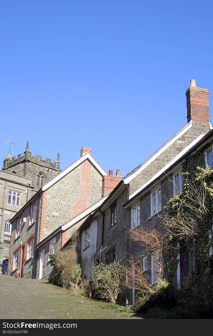 Steep hill and sky in English town