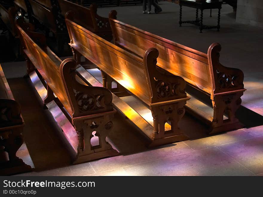 Colorful ray of lights on some benches inside St Peters Cathedral, Geneva, Switzerland. Colorful ray of lights on some benches inside St Peters Cathedral, Geneva, Switzerland.