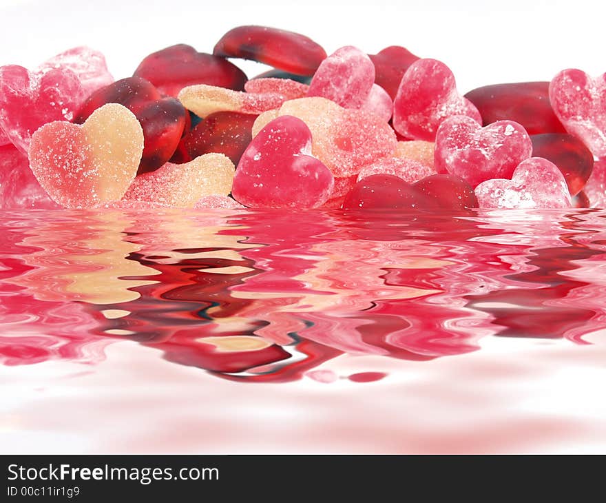 Colorful pastel candy heart soft candies with waves reflections