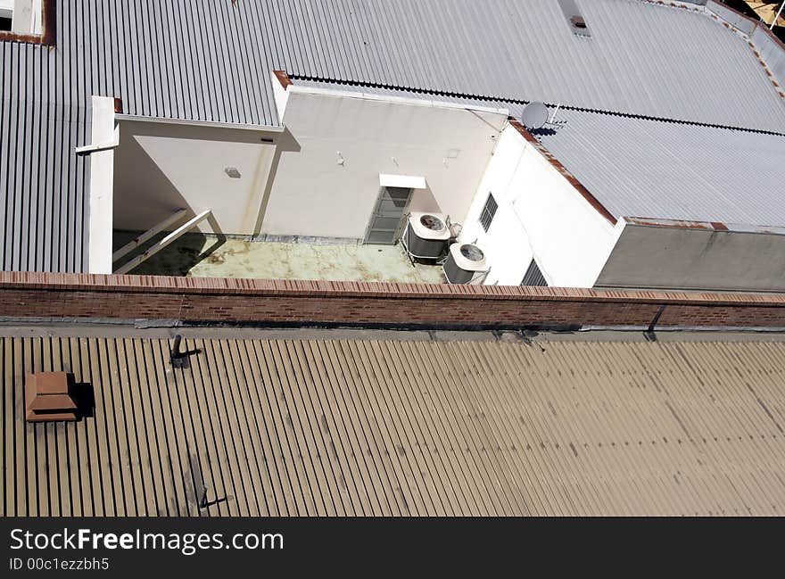 Blue And Brown Roofs Of Urban City Buildings, Door And Little Yard. Blue And Brown Roofs Of Urban City Buildings, Door And Little Yard