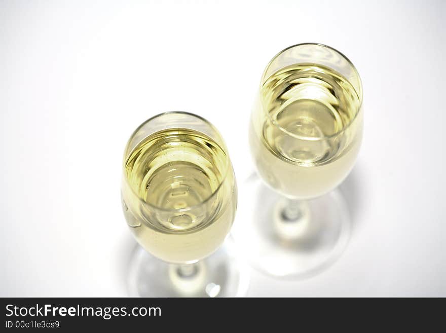 Two glasses of sparkeling wine and a white background