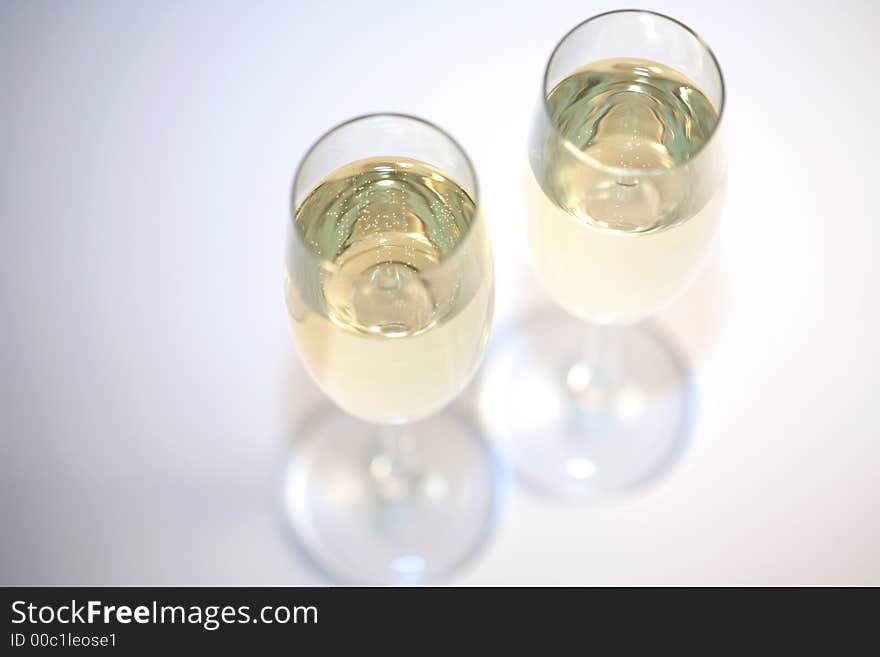 Two glasses of sparkeling wine and a white background