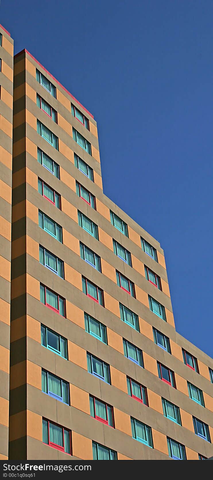 Highrise apartment building with different  colored windows. Highrise apartment building with different  colored windows