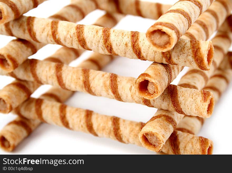 Heap of striped wafer tubules with the chocolate cream, isolated, (look similar images in my portfolio)