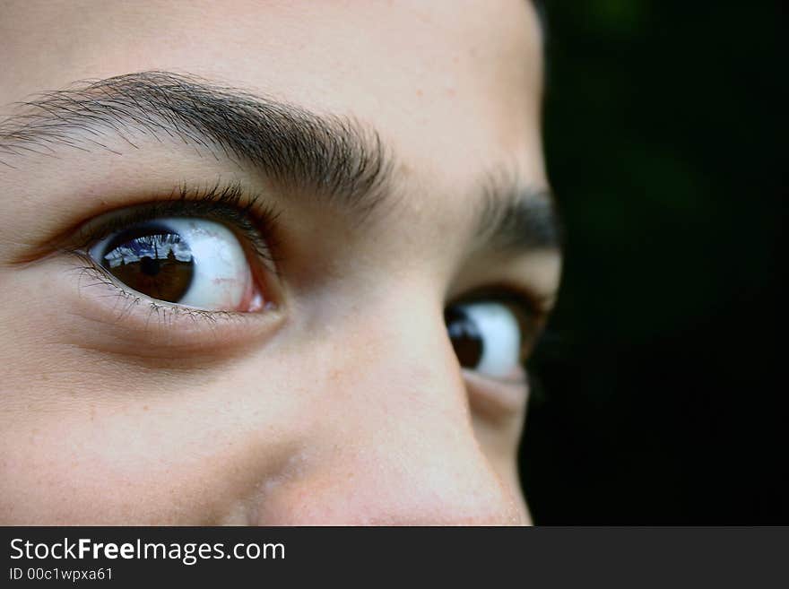 Teen face. Close-up. Background black. Teen face. Close-up. Background black.