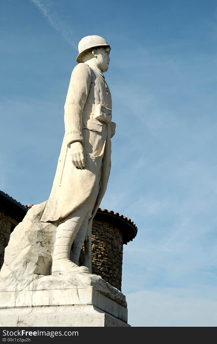 First and second war memorial statue against a blue sky