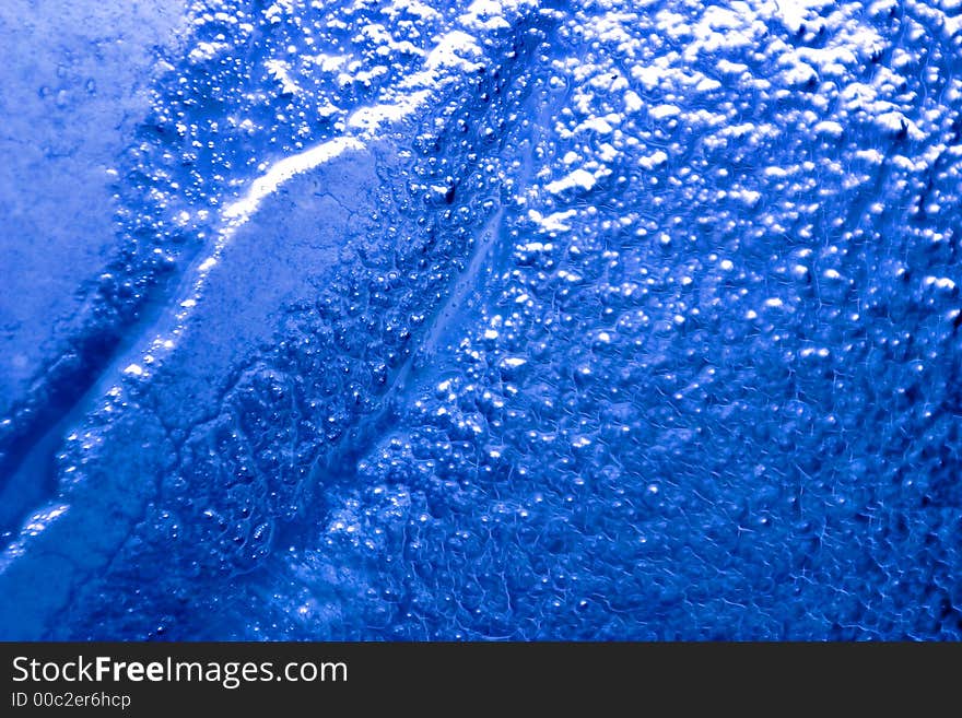 Detail of a bubbled glass with blu natural gradient. Detail of a bubbled glass with blu natural gradient