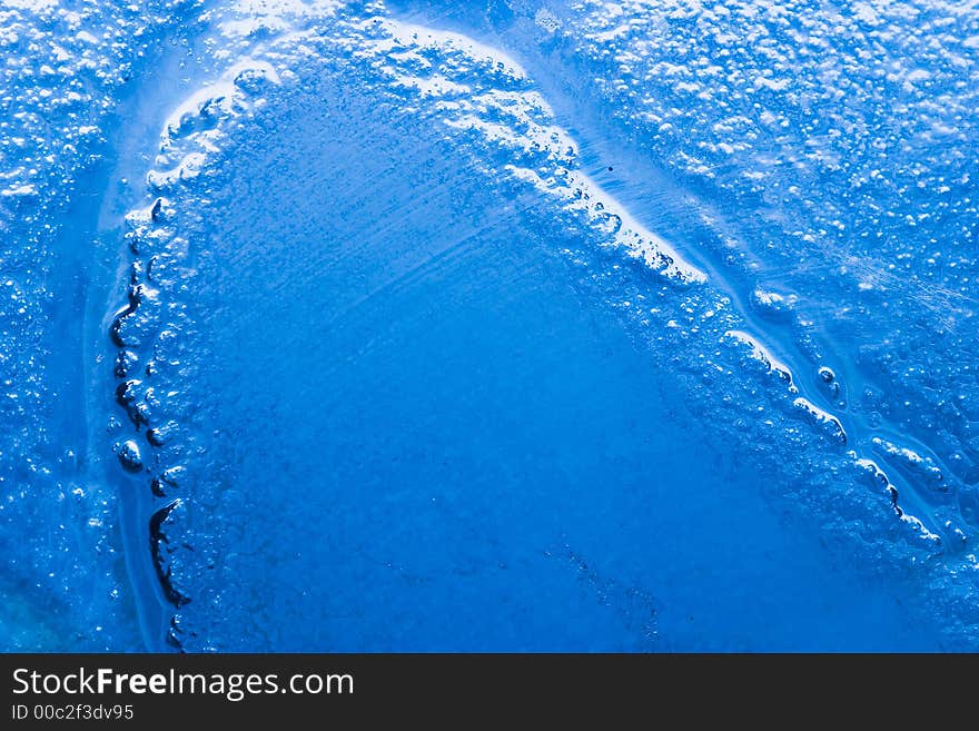 Detail of a bubbled glass with blu natural gradient. Detail of a bubbled glass with blu natural gradient