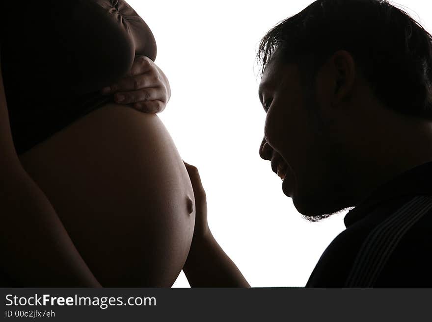 Silhouette of a father talks to his unborn baby. Silhouette of a father talks to his unborn baby