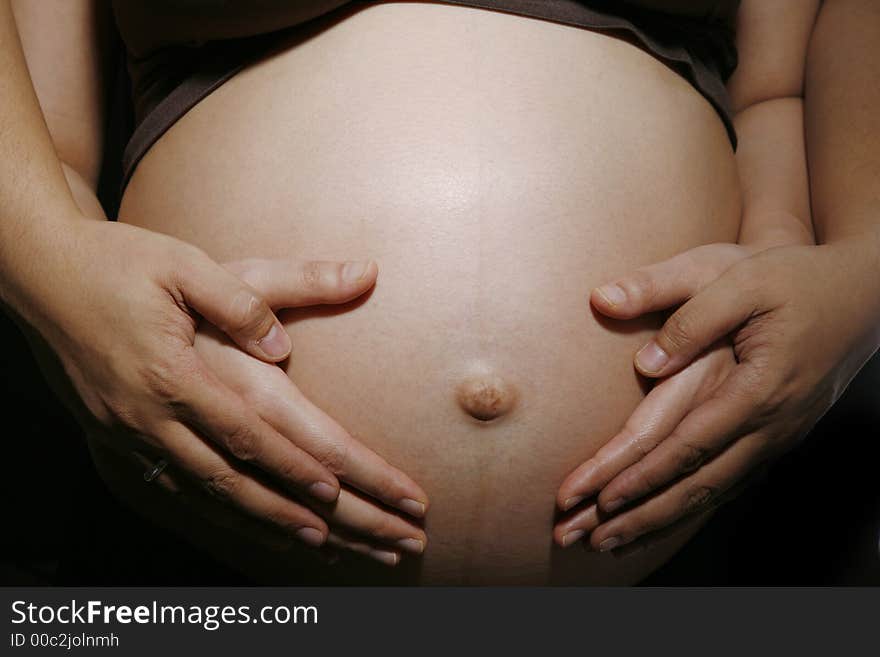 Pregnant woman & husband with their hands on a belly. Pregnant woman & husband with their hands on a belly