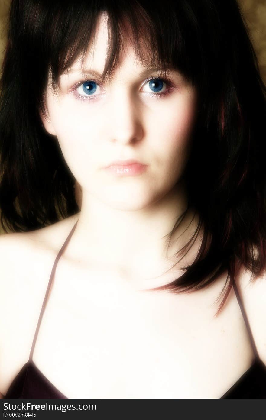 Close up of beautiful teen girl with black hair and blue eyes.