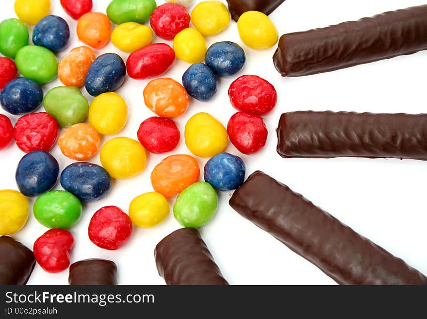 Chocolate sticks with a cream and the multi-coloured sweets isol