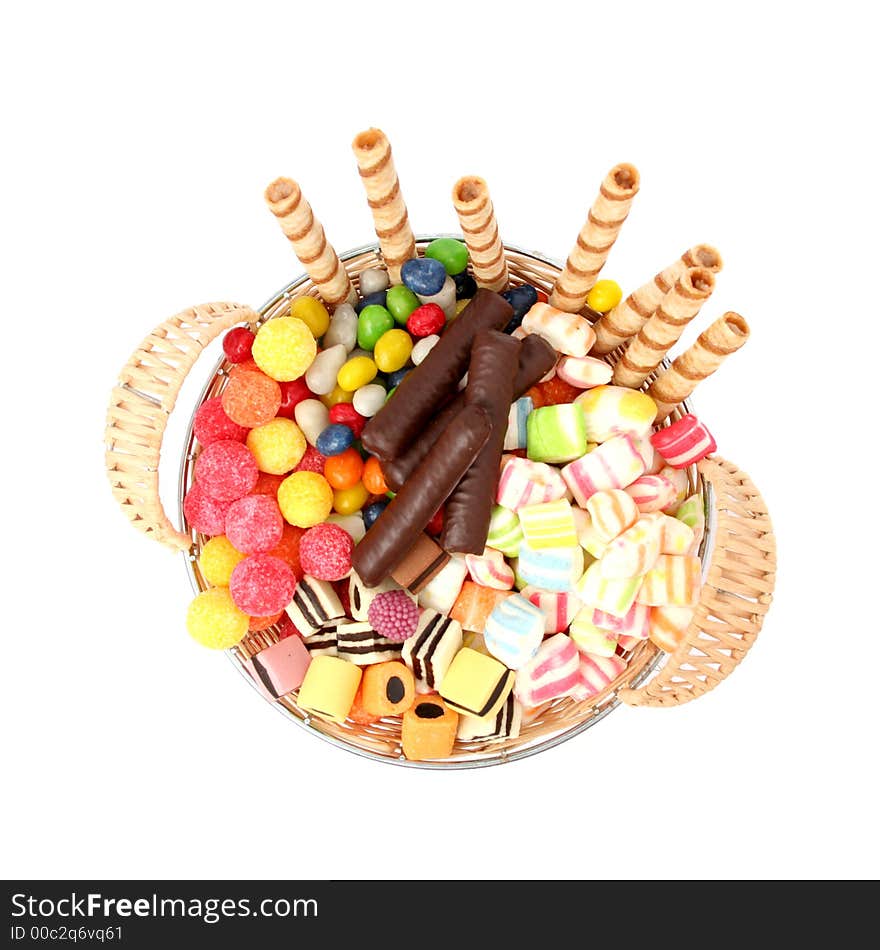 Basket with various sweets and the cookies, isolated