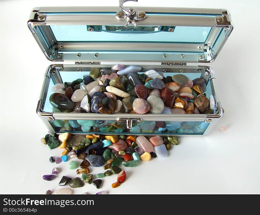 Gem stones in a clear blue treasure chest. Gem stones in a clear blue treasure chest