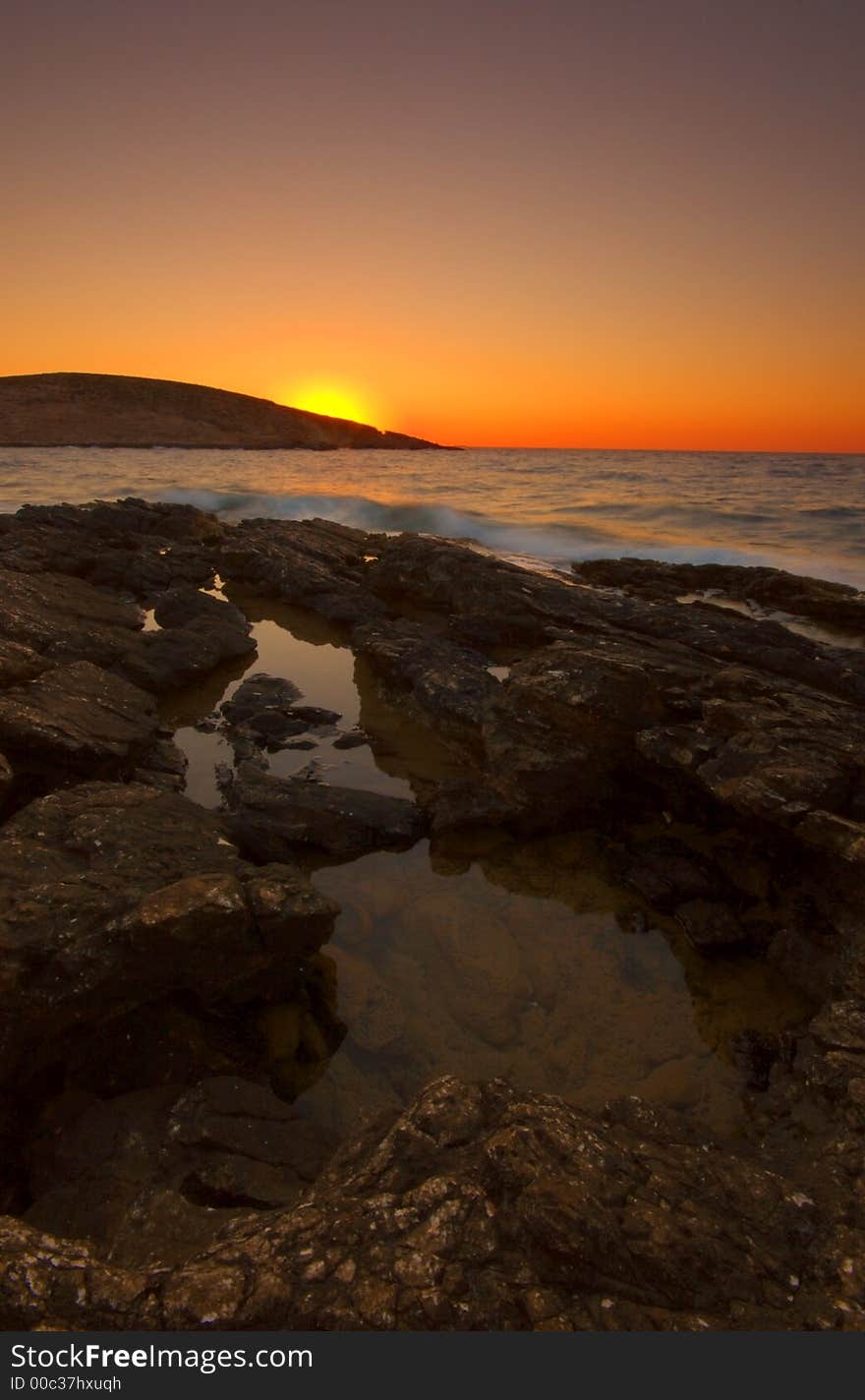 Sunset over rock greek coast. Sunset over rock greek coast