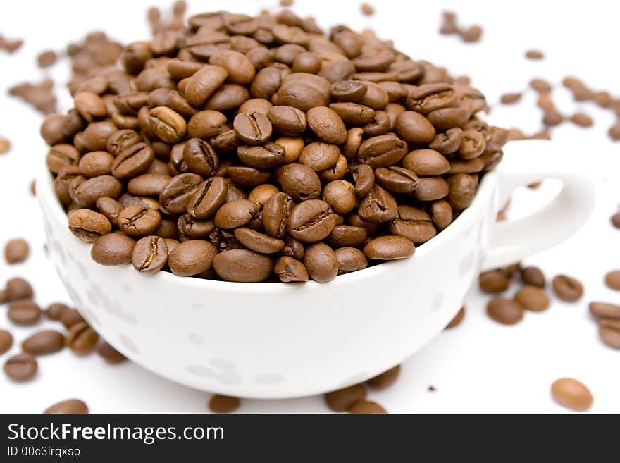 Coffe beans in a cup isolated on a white background. Coffe beans in a cup isolated on a white background.