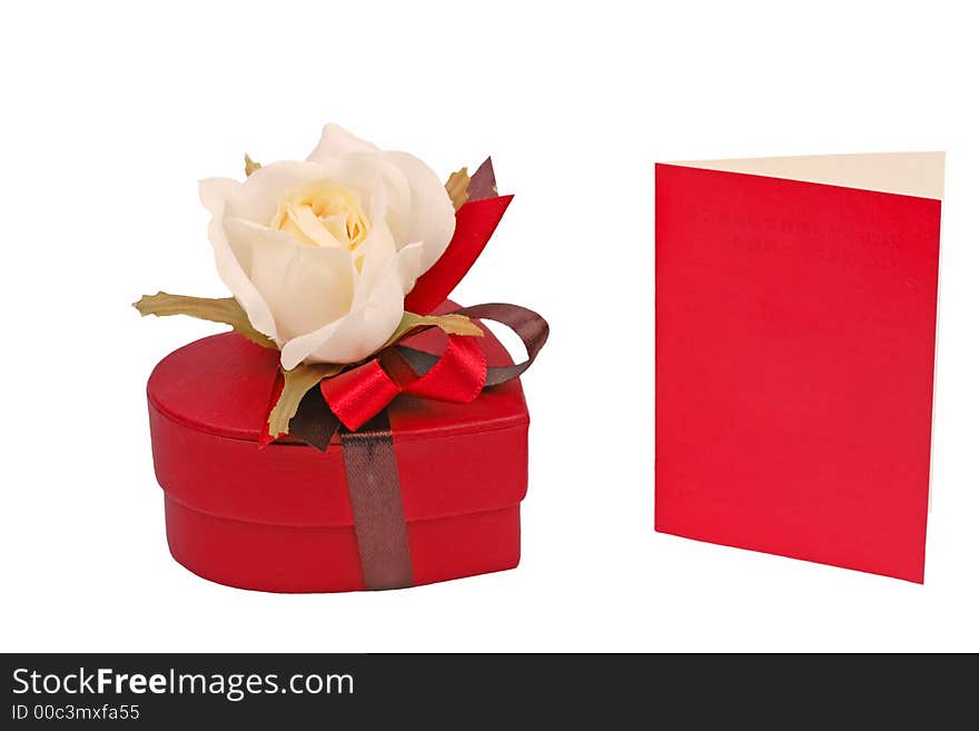 Heart shape red chocolate box with rose and a red card isolated over white background. Heart shape red chocolate box with rose and a red card isolated over white background