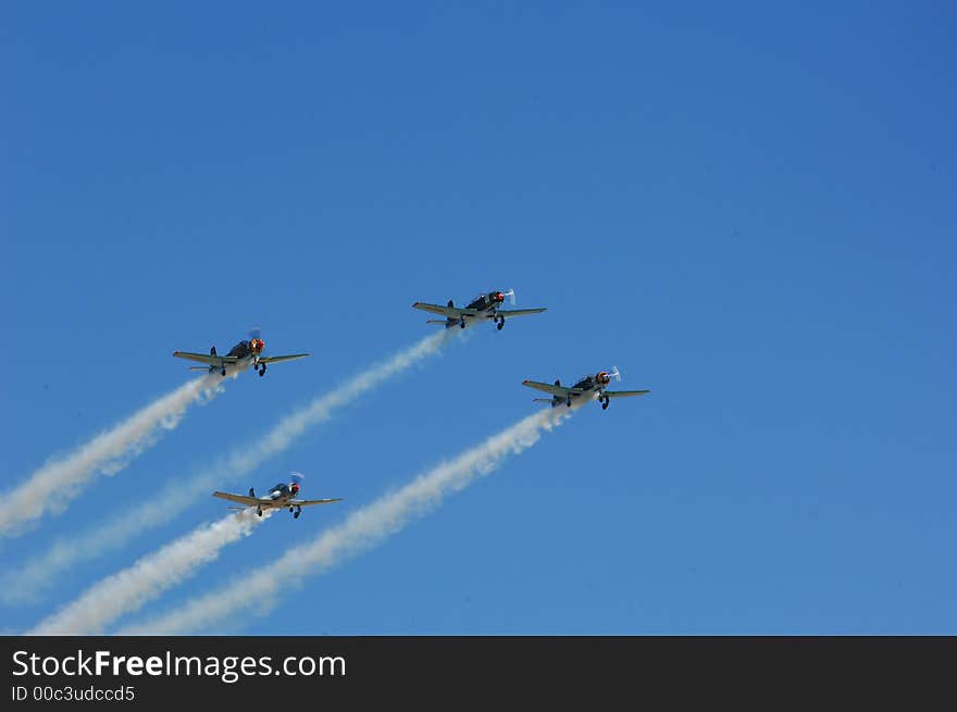 Russian Yakovlev Aircraft flying in formation at an Airshow. Russian Yakovlev Aircraft flying in formation at an Airshow