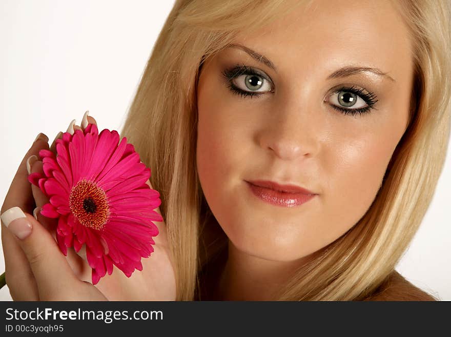 A woman holding a daisy in her hands. A woman holding a daisy in her hands