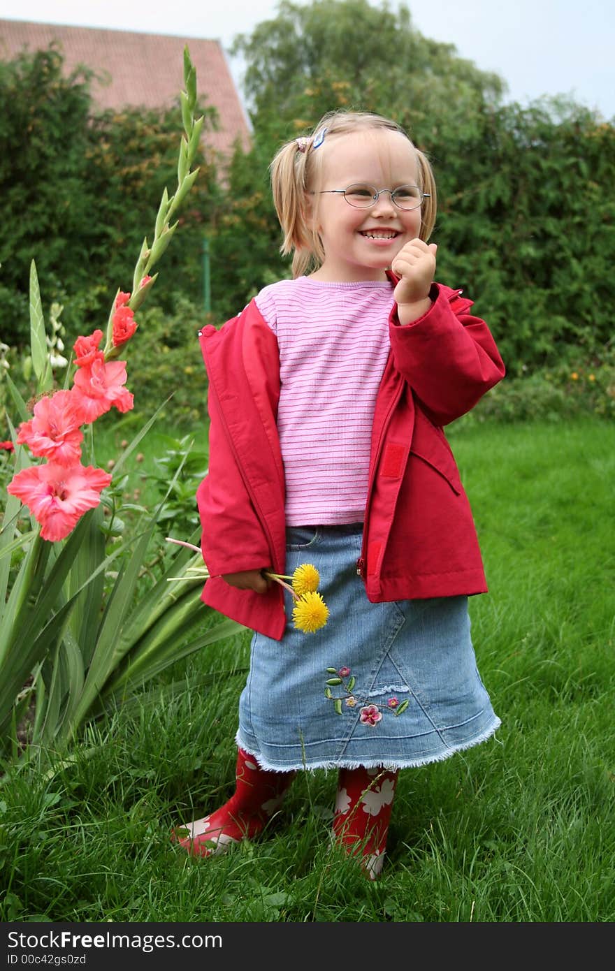 A smiling girl outdoors wearing glasses. A smiling girl outdoors wearing glasses