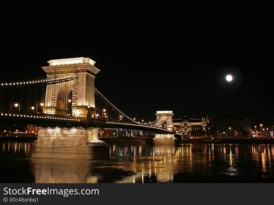 Szechenyi Chain Bridge connecting Buda and Pest sides of the Hungarian capital Budapest at full moon