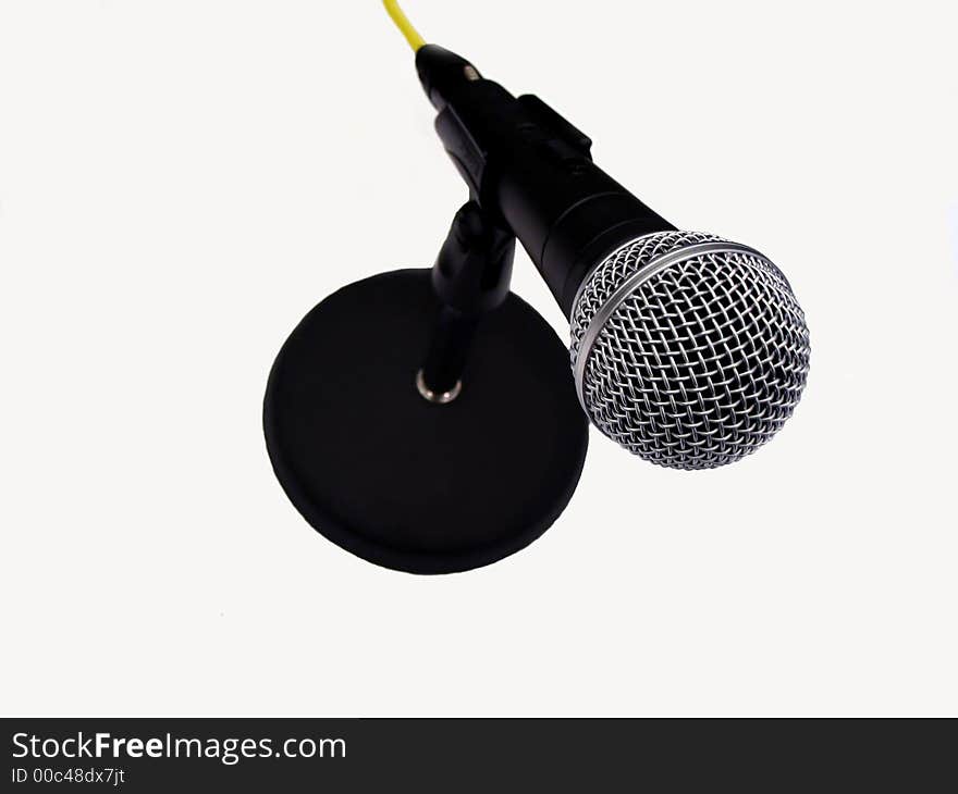 This is a picture of a microphone on a table stand isolated on a white background.