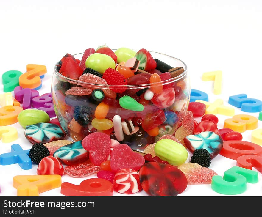 Colorful pastel candy and play numbers on glass bowl. Colorful pastel candy and play numbers on glass bowl