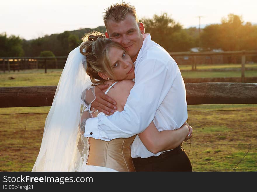 Married couple hugging each other after the wedding ceremony. Married couple hugging each other after the wedding ceremony.