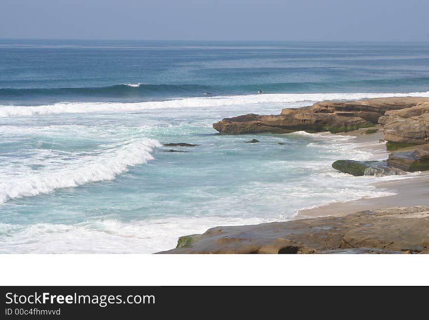 This is a picture of the shoreline at Windandsea Beach with a glimpse of rocks and surfers. This is a picture of the shoreline at Windandsea Beach with a glimpse of rocks and surfers.