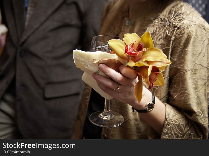 A woman holding her drink with flowers. A woman holding her drink with flowers