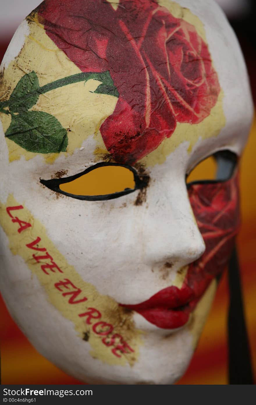 A venice carnival mask in white with roses. A venice carnival mask in white with roses.